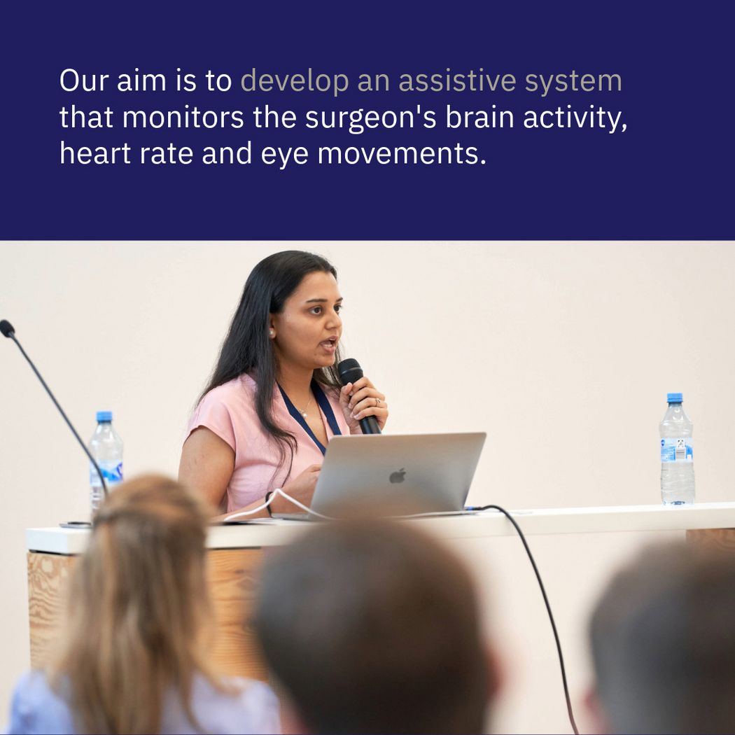 Photo of Mansi Sharma presenting at a conference, quote: Our aim is to develop an assistive system that monitors the surgeon's brain activity, heart rate and eye movements.
